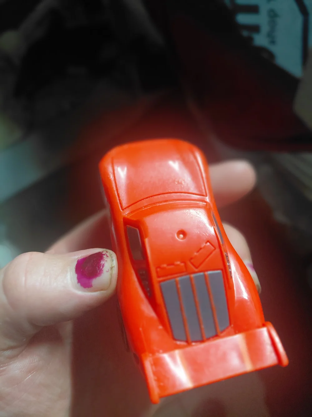 red Disney Pixar Lightning McQueen toy car, appearing to be a plastic model.